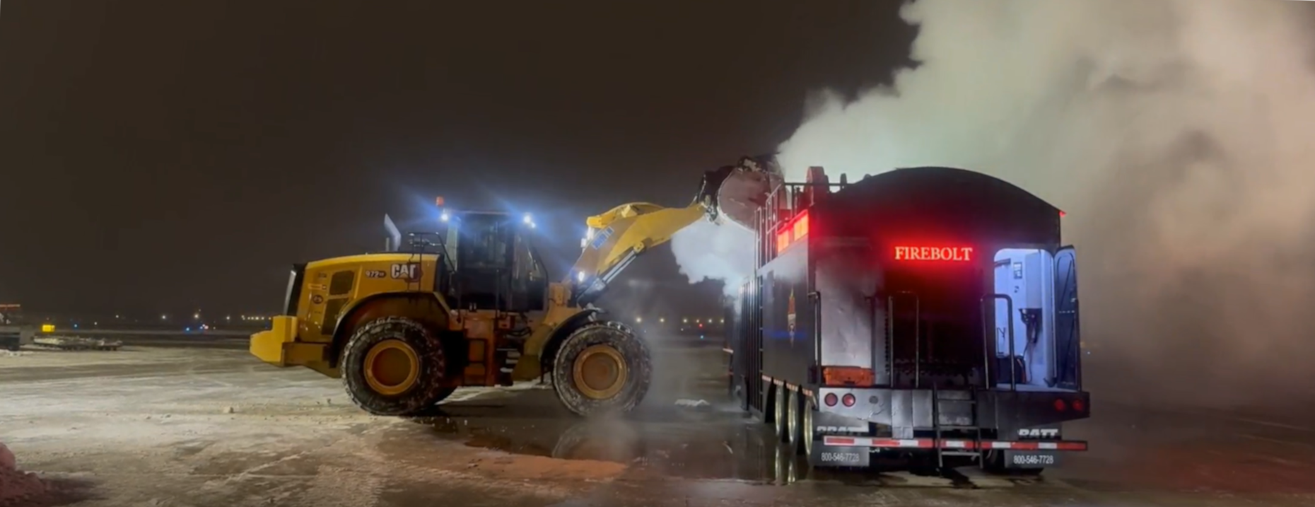 A CAT loader loading a snowmelter